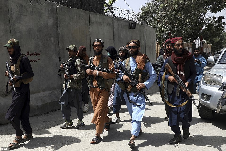46811063-9904067-Taliban_fighters_patrol_in_Wazir_Akbar_Khan_neighborhood_in_the_-a-22_1629297317829